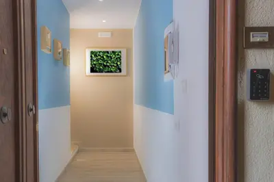a hallway with blue walls and a door at Green Garden in Rome