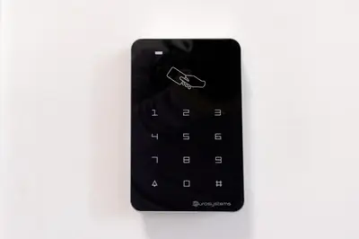 a black remote control hanging on a wall at Green Garden in Rome