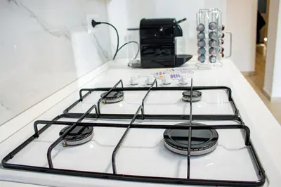 a stove top with four burners on a kitchen counter at Green Garden in Rome