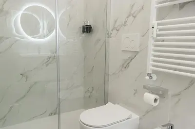 a white bathroom with a shower and a toilet at Green Garden in Rome
