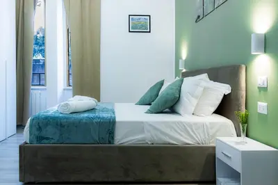 a bedroom with a bed with pillows on it at Green Garden in Rome