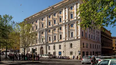 a large white building with people standing in front of it at Princeps Boutique Hotel in Rome