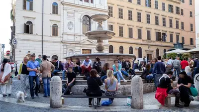 a group of people sitting around a fountain at Princeps Boutique Hotel in Rome