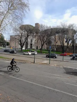 a person riding a bike down a street at Acche Apartments in Rome