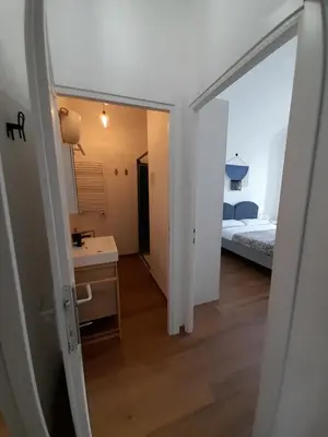 a room with a bedroom and a bed and a mirror at Acche Apartments in Rome