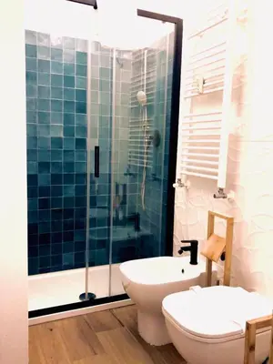 a bathroom with a toilet and a sink and a shower at Acche Apartments in Rome