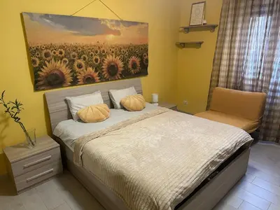 a bedroom with a bed with a painting on the wall at Sunflower Rome in Rome