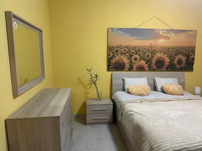a bedroom with a bed with a painting on the wall at Sunflower Rome in Rome