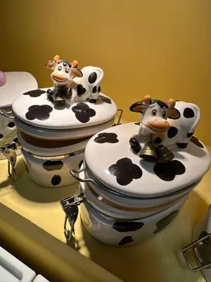 two fake cows sitting on top of two toilets at Sunflower Rome in Rome