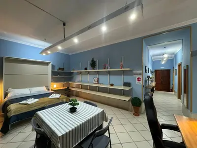 a bedroom with a bed and a table and chairs at Charming Hideaway in P R A T I near Piazza Clodio in Rome