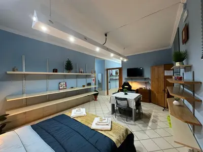 a bedroom with a bed and a table in a room at Charming Hideaway in P R A T I near Piazza Clodio in Rome
