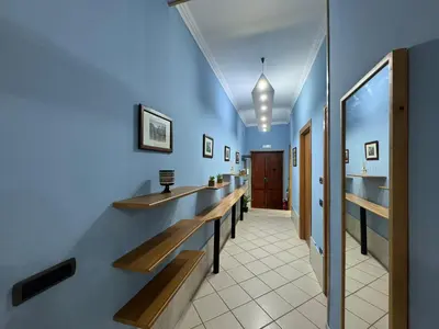 a hallway with wooden benches and a blue wall at Charming Hideaway in P R A T I near Piazza Clodio in Rome