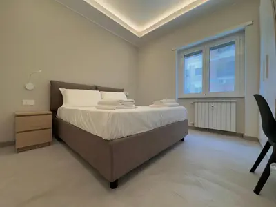 a bedroom with a large bed and a window at Domus Romae in Rome