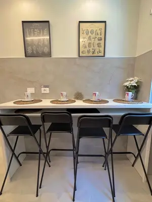 a table with four chairs in a room at Domus Romae in Rome