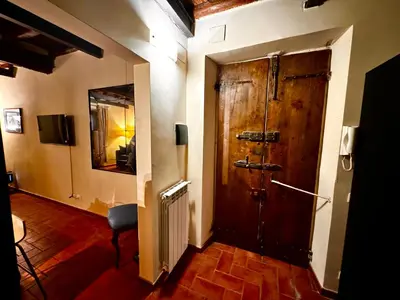 a hallway with a large wooden door in a room at Casa dolce Casa Trastevere in Rome