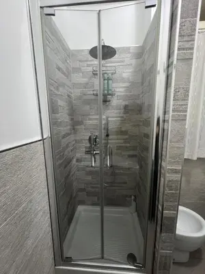 a bathroom with a sink and a toilet and a mirror at Monteverde COME a casa -HOME- in Rome
