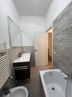 a bathroom with a white tub and a sink and a bath tub at Monteverde COME a casa -HOME- in Rome