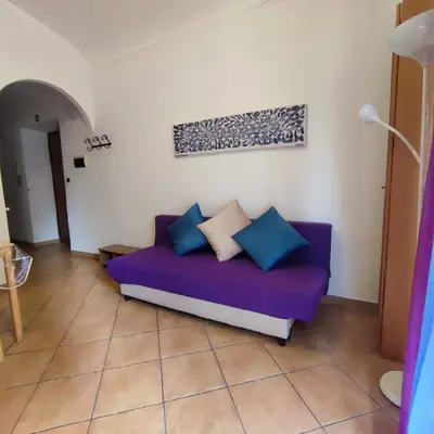 a purple couch sitting in a living room at Casa Cartoni in Rome