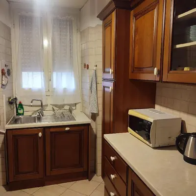 a kitchen with a sink and a microwave at Casa Cartoni in Rome