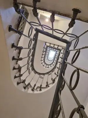 a spiral staircase with a window in a building at appartamento monticiano in Rome