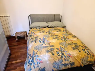 a bedroom with a bed with a colorful blanket at appartamento monticiano in Rome