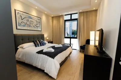 a bedroom with a large bed and a television at Vaticano Appartamento Suite Roma Centro Aura D1 in Rome