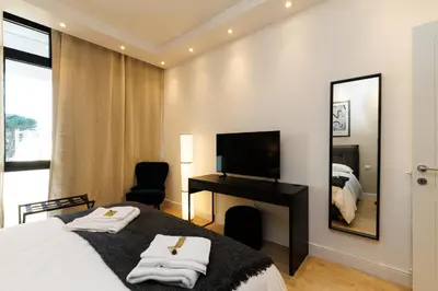 a bedroom with a bed and a desk and a television at Vaticano Appartamento Suite Roma Centro Aura D1 in Rome