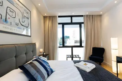 a bedroom with a bed and a chair and a window at Vaticano Appartamento Suite Roma Centro Aura D1 in Rome