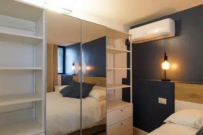 a bedroom with two beds and a mirrored closet at Vaticano Appartamento Suite Roma Centro Aura D1 in Rome