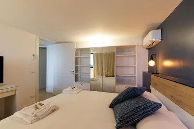 a bedroom with a bed with two towels on it at Vaticano Appartamento Suite Roma Centro Aura D1 in Rome