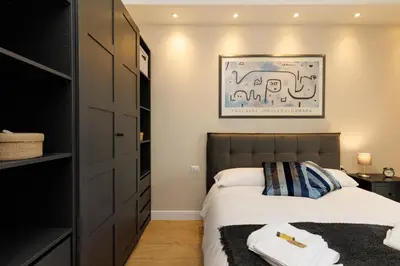 a bedroom with a bed and a picture on the wall at Vaticano Appartamento Suite Roma Centro Aura D1 in Rome