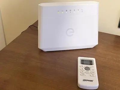 a remote control sitting on a table next to a appliance at Home Roma Testaccio in Rome