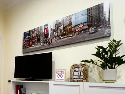 a flat screen tv sitting on top of a white cabinet at Home Roma Testaccio in Rome