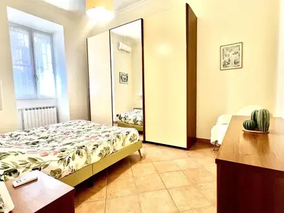 a bedroom with a bed and a large mirror at Home Roma Testaccio in Rome