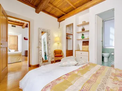 a bedroom with a large bed and a bathroom at Il Mandorlo a Monti in Rome