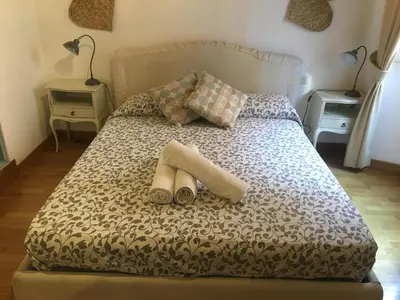 a bedroom with a bed with two slippers on it at Il Mandorlo a Monti in Rome