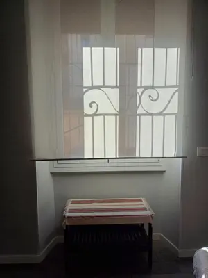 a window with a bench in front of it at Room and Apartment Rome in Rome