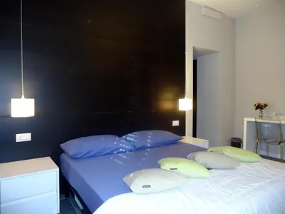 a bedroom with a blue bed with two pillows at Room and Apartment Rome in Rome