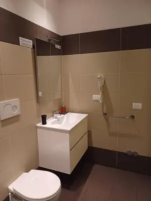 a bathroom with a white sink and a toilet at Room and Apartment Rome in Rome