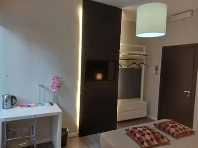 a room with a black wall with a fireplace in it at Room and Apartment Rome in Rome