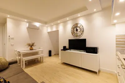 a living room with a flat screen tv on a white wall at Vaticano Appartamento Suite Roma Centro Aura D4 in Rome