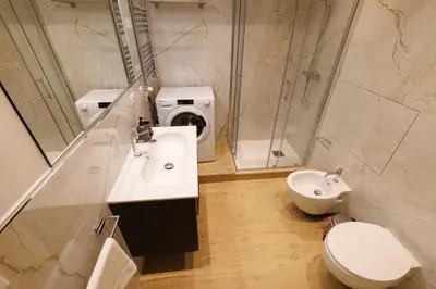 a bathroom with a sink and a toilet and a shower at Vaticano Appartamento Suite Roma Centro Aura D4 in Rome