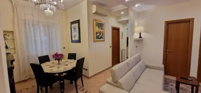a living room with a table and a couch at OASI - Vaticano 3Clima Netflix Wi-Fi Parking Garden in Rome
