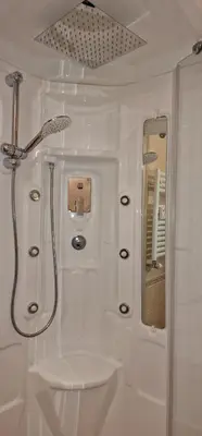 a white bathroom with a shower and a sink at OASI - Vaticano 3Clima Netflix Wi-Fi Parking Garden in Rome
