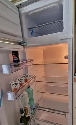 an open refrigerator with its door open and food inside at OASI - Vaticano 3Clima Netflix Wi-Fi Parking Garden in Rome