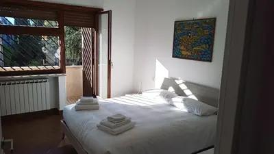 a bedroom with a bed with towels on it at Appartamento moderno con vista sul verde 2 fermate da San Pietro in Rome