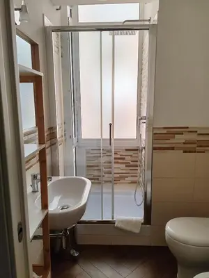 a bathroom with a shower and a sink and a toilet at Appartamento moderno con vista sul verde 2 fermate da San Pietro in Rome