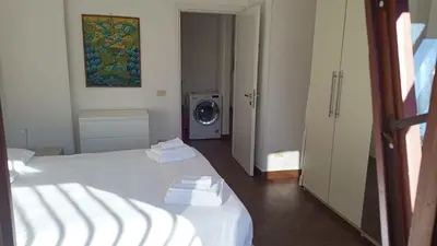 a room with two beds and a washing machine at Appartamento moderno con vista sul verde 2 fermate da San Pietro in Rome