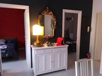 a room with a white cabinet with a lamp and a mirror at YourStay@Rome Vatican in Rome