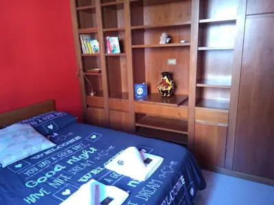 a bedroom with a bed and a book shelf at YourStay@Rome Vatican in Rome